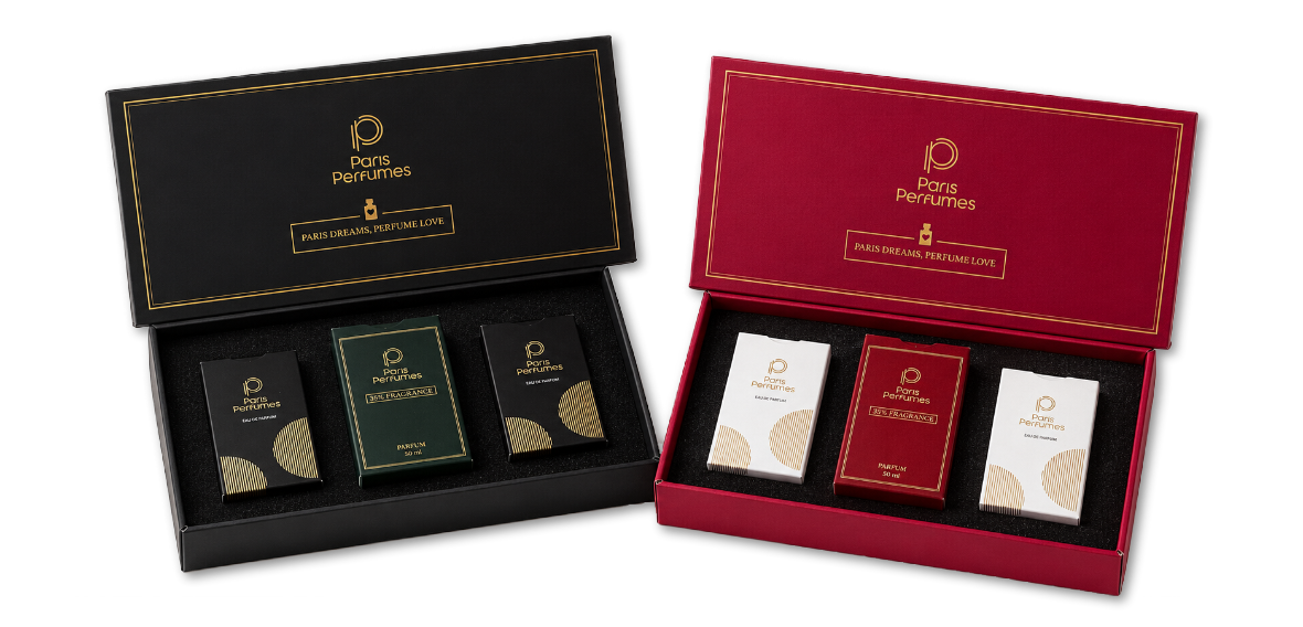 Kaks avatud Paris Perfumes kinkekarpi, must ja bordoopunane, kummaski kolm pudelit